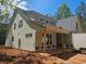 Side view of exterior with new construction showcasing a covered porch, siding, and natural wooded backdrop at 6821 Phillips Mill Rd, Douglasville, GA 30135