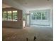 Open concept living space with large windows, unfinished floors, and ample natural light at 6821 Phillips Mill Rd, Douglasville, GA 30135