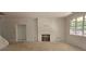 Unfinished living room with framed fireplace, large window, and natural light ready to be customized at 6821 Phillips Mill Rd, Douglasville, GA 30135