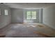 Expansive room featuring bright light from generous windows offering views of surrounding greenery at 6821 Phillips Mill Rd, Douglasville, GA 30135