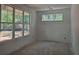 Bright room with large windows offering serene views of the surrounding wooded landscape at 6821 Phillips Mill Rd, Douglasville, GA 30135