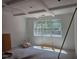 Spacious room showcasing a modern coffered ceiling and large window framing wooded scenery at 6821 Phillips Mill Rd, Douglasville, GA 30135