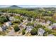 An aerial view of a suburban neighborhood with tree-lined streets and mountain views in the distance at 1857 Barrington Ct, Marietta, GA 30066