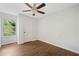 Bedroom features hardwood floors, a ceiling fan, and a window providing natural light at 1857 Barrington Ct, Marietta, GA 30066