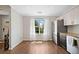 Bright dining area with wood floors and a large window with sheer curtains at 1857 Barrington Ct, Marietta, GA 30066