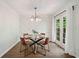 Bright dining area with modern lighting, a glass-topped table and French doors to the outside at 1857 Barrington Ct, Marietta, GA 30066