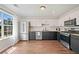 Modern kitchen with stainless steel appliances, granite counters, and wood flooring at 1857 Barrington Ct, Marietta, GA 30066