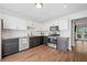 Modern kitchen with stainless steel appliances, granite counters, and wood flooring at 1857 Barrington Ct, Marietta, GA 30066