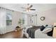 Bright main bedroom with modern décor, tray ceiling, ceiling fan, and natural light through the windows at 1857 Barrington Ct, Marietta, GA 30066