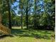 Spacious backyard with lush greenery, mature trees, and a fenced area, perfect for outdoor activities at 2131 Glendale Dr, Decatur, GA 30032