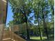 A back deck overlooking a very green backyard and adjacent to tall trees at 2131 Glendale Dr, Decatur, GA 30032