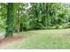 Expansive grassy backyard surrounded by mature trees and greenery at 2131 Glendale Dr, Decatur, GA 30032