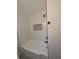 The bright bathroom features a tub with white tiling and modern fixtures at 2131 Glendale Dr, Decatur, GA 30032