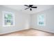 Well-lit bedroom features modern floors, neutral walls, ceiling fan, and two windows for natural light at 2131 Glendale Dr, Decatur, GA 30032