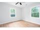 Bright bedroom with two windows and a ceiling fan features modern flooring and neutral paint at 2131 Glendale Dr, Decatur, GA 30032