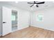 Bright bedroom featuring hardwood floors, a ceiling fan, and an ensuite bathroom at 2131 Glendale Dr, Decatur, GA 30032