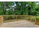 Exterior wood deck with wooden railings overlooking a beautifully wooded backyard at 2131 Glendale Dr, Decatur, GA 30032