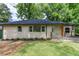 Charming single-story home featuring a freshly manicured lawn and classic light brick facade at 2131 Glendale Dr, Decatur, GA 30032