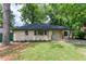 Charming single-story home featuring a freshly manicured lawn and classic light brick facade at 2131 Glendale Dr, Decatur, GA 30032