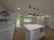 Modern kitchen with white cabinets, marble counters, and a center island with pendant lighting at 2131 Glendale Dr, Decatur, GA 30032
