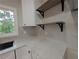 Close up of quartz countertops, undermount sink, floating shelves and bright window at 2131 Glendale Dr, Decatur, GA 30032