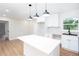 Bright, renovated kitchen featuring an island, white cabinets, stainless steel appliances, and hardwood floors at 2131 Glendale Dr, Decatur, GA 30032