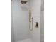 Shower with white and grey tile walls featuring luxurious gold fixtures and a rainfall shower head at 2131 Glendale Dr, Decatur, GA 30032