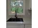 Close-up of kitchen sink and window overlooking green trees and a deck at 2131 Glendale Dr, Decatur, GA 30032