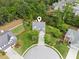 Aerial view of a home nestled amongst lush trees, showcasing its well-manicured lawn and serene surroundings at 2173 Beacon Crest Dr, Buford, GA 30519