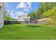 Fenced backyard with green grass and trampoline at 2173 Beacon Crest Dr, Buford, GA 30519