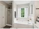 Inviting bathroom with a soaking tub, separate shower, and natural light at 2173 Beacon Crest Dr, Buford, GA 30519