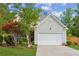 Charming two-story home features a well-maintained lawn, attached two-car garage, and mature landscaping at 2173 Beacon Crest Dr, Buford, GA 30519