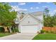 Charming two-story home boasts lush landscaping, an attached two-car garage, and mature trees at 2173 Beacon Crest Dr, Buford, GA 30519
