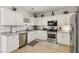 Bright kitchen featuring stainless steel appliances, white cabinets, and neutral countertops at 2173 Beacon Crest Dr, Buford, GA 30519