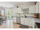 Bright kitchen with white cabinets, stainless steel appliances, tile backsplash, and eat in breakfast area at 2173 Beacon Crest Dr, Buford, GA 30519