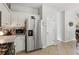 This kitchen has stainless appliances, white cabinets, tile floors and backsplash and lots of counter space at 2173 Beacon Crest Dr, Buford, GA 30519