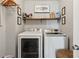 Functional laundry room with modern washer and dryer, shelving for storage, and organized space at 2173 Beacon Crest Dr, Buford, GA 30519