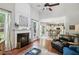 Open-concept living area with fireplace, hardwood floors, and lots of natural light at 2173 Beacon Crest Dr, Buford, GA 30519
