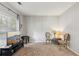 Cozy living room featuring neutral carpet, ample natural light, and a decorative sitting area at 2173 Beacon Crest Dr, Buford, GA 30519