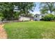 Backyard featuring a grassy area with a storage shed and partial fencing at 220 Sisson Ne Ave, Atlanta, GA 30317