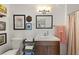 Updated bathroom with modern vanity, framed art, and decorative shower curtain at 220 Sisson Ne Ave, Atlanta, GA 30317