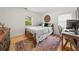 Cozy bedroom with hardwood floors, a comfortable bed, and a dedicated workspace for a versatile living area at 220 Sisson Ne Ave, Atlanta, GA 30317