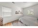 Bright bedroom with hardwood floors, a neutral rug, and sun-filled windows with blinds at 220 Sisson Ne Ave, Atlanta, GA 30317