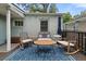 Outdoor deck featuring a table, rocking chairs, and a blue rug, creating a relaxing seating area at 220 Sisson Ne Ave, Atlanta, GA 30317