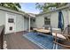 Back deck area featuring outdoor seating, a blue rug, and string lights for a cozy and inviting atmosphere at 220 Sisson Ne Ave, Atlanta, GA 30317