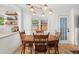 Charming dining room with modern light fixture and views of the manicured backyard at 220 Sisson Ne Ave, Atlanta, GA 30317