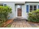 Close-up of the home's front entrance with a glass door, blue shutters, and brick pathway at 220 Sisson Ne Ave, Atlanta, GA 30317