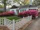 Home exterior with green lawn and azalea bushes, framed by a white picket fence at 220 Sisson Ne Ave, Atlanta, GA 30317