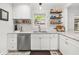 Bright and updated kitchen with stainless steel appliances, open shelving, and granite countertops at 220 Sisson Ne Ave, Atlanta, GA 30317