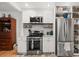Well-lit kitchen with stainless steel appliances, white cabinets, and functional shelving, perfect for storage at 220 Sisson Ne Ave, Atlanta, GA 30317